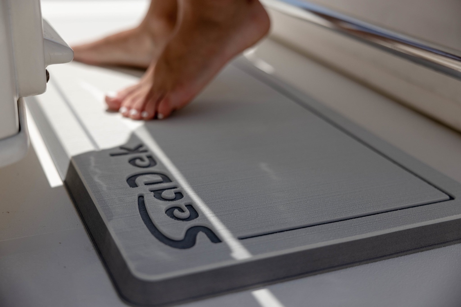 SeaDek helm pad with the SeaDek logo, on a boat over the water
